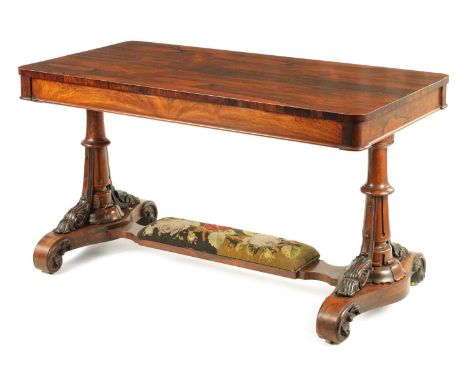 A MID 19TH CENTURY CARVED ROSEWOOD LIBRARY TABLE with one long frieze drawer; standing on carved column legs with tapestry un