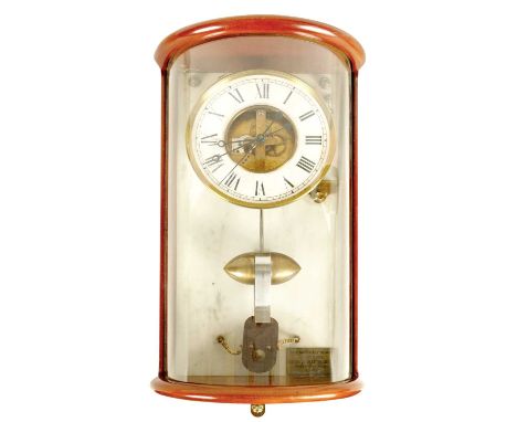 PAUL MORET, 1933. A BOULLE STYLE ELECTRIC WALL CLOCK the bow front mahogany glazed case enclosing a 7" skeletonised dial with