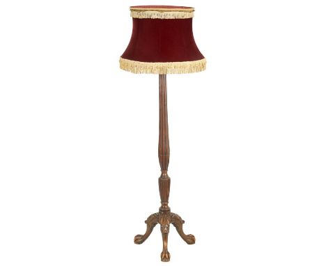 AN 18TH CENTURY STYLE MAHOGANY STANDARD LAMP with fluted carved tapering stem and vase-shaped lower body on a leaf carved tri