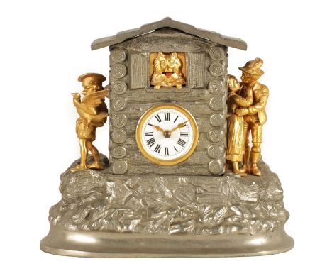 A LATE 19TH CENTURY FRENCH AUTOMATION MANTEL CLOCK the polished metal and ormolu case modelled as a log house with figural mo