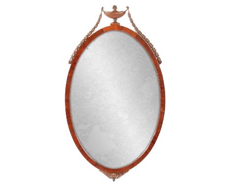A LATE 19TH CENTURY ADAM STYLE MAHOGANY OVAL HANGING MIRROR with draped urn cresting84cm high 