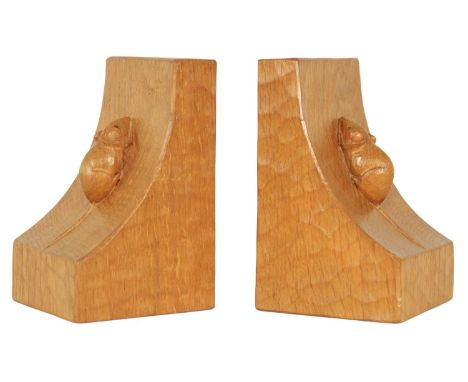 A GOOD PAIR OF ROBERT 'MOUSEMAN' THOMPSON AZED OAK BOOKENDS of curved angular form with bold carved mouse motifs.15.5cm high