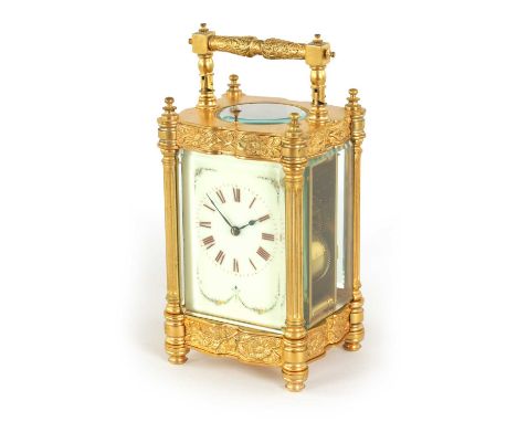 A LARGE GILT BRASS LATE 19TH CENTURY FRENCH REPEATING CARRIAGE CLOCK the shaped case with floral decoration and reeded column