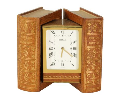 A VINTAGE NOVELTY JAEGER DESK CLOCK disguised as a pair of books hinging open to reveal a brass cased clock with white dial a