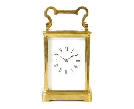 A LATE 19TH CENTURY BRASS CASED FRENCH STRIKING CARRIAGE CLOCK the enamel dial with Roman numerals fronting an eight-day spri
