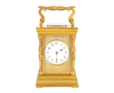 A LATE 19TH CENTURY GILT BRASS FRENCH STRIKING CARRIAGE CLOCK with engine turned mask, enamel dial and Arabic numerals fronti