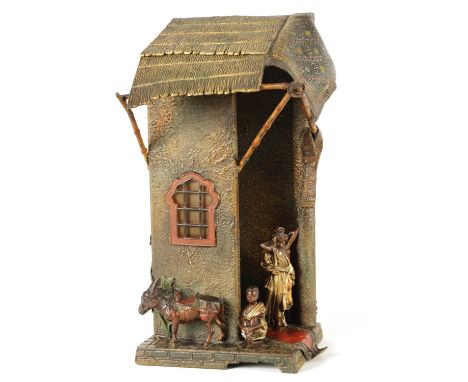 AN EARLY 20TH CENTURY BERGMAN STYLE COLD-PAINTED METAL TABLE LAMP depicting an eastern house with figures and a donkey32cm hi