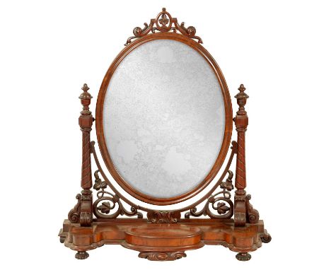 A LATE VICTORIAN FIGURED MAHOGANY DRESSING TABLE MIRROR of elaborate leaf carved design with oval swing mirror and shaped bas