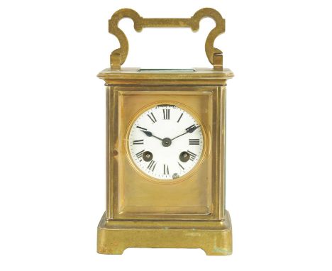 A LATE 19TH CENTURY FRENCH OVERSIZED CARRIAGE TYPE BRASS MANTEL CLOCK The glazed case with shaped folding handle and masked e