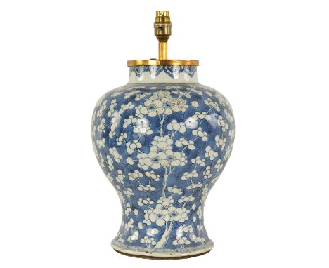 A CHINESE KANGXI PERIOD INVERTED BALUSTER BLUE AND WHITE VASE with overall prunus blossom decoration - later converted to a t