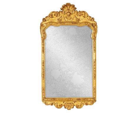 A GEORGE II GILT GESSO HANGING MIRROR with portrait cresting having a carved shell and scrolled leafwork decoration112cm high