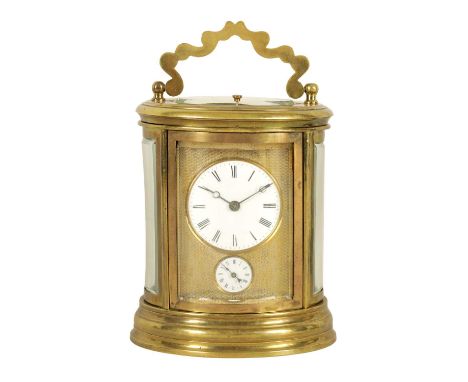 A LATE 19TH CENTURY FRENCH OVAL REPEATING CARRIAGE CLOCK the brass case with engine turned masked dial enclosing an enamelled