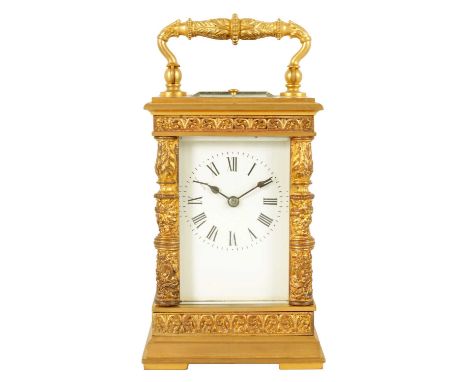 A LATE 19TH CENTURY FRENCH GILT BRASS CASED REPEATING CARRIAGE CLOCK with acanthus leaf decoration and cast masked corner pil