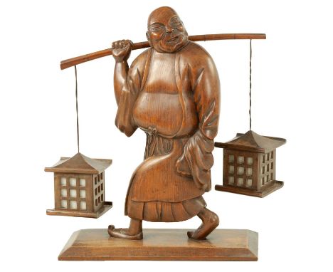A 19TH CENTURY CARVED WOOD SCULPTURE LAMP modelled as a buddha carrying two lanterns.55cm high