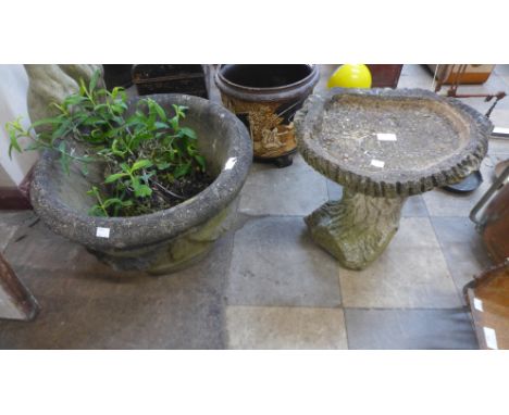 A concrete garden bird bath and a planter 