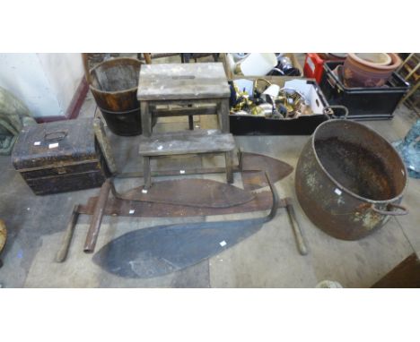 A cast iron cauldron, a tin trunk, tools, etc. 