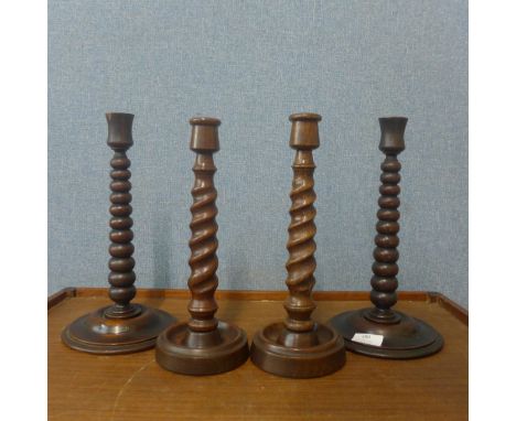 A pair of oak bobbin turned candlesticks, labelled; Made from timber taken from HMS Britannia and two others 