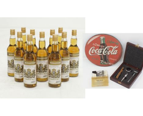 A collection of eleven bottles of one star Haggipavlu brandy together with a vintage Coke ad., measuring 26cm in diameter and