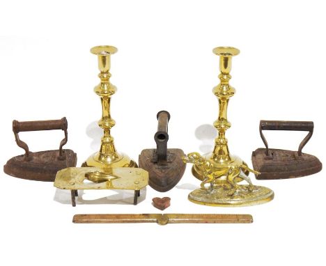 Three vintage clothes irons&nbsp;by T Sheldon &amp; Co, Salter, the other indistinctly stamped, a pair of brass candlesticks,