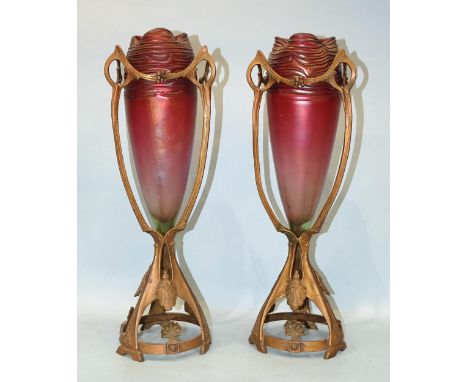A pair of gilt metal Loetz-style iridescent vases of tapered baluster form, on gilt metal stands of hourglass shape, 45cm hig