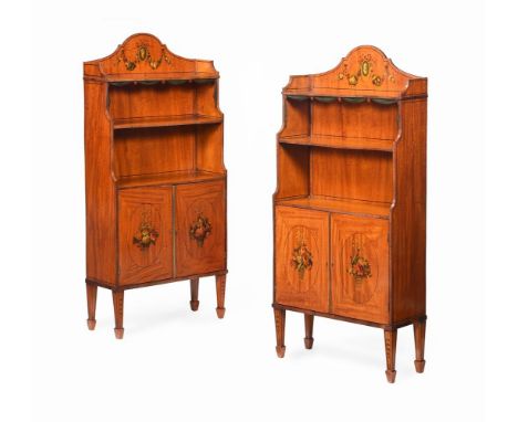 Y A PAIR OF EDWARDIAN SATINWOOD AND POLYCHROME PAINTED WATERFALL OPEN BOOKCASES IN GEORGE III STYLE, CIRCA 1905 The doors ope