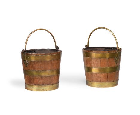 A PAIR OF OAK AND BRASS BOUND BUCKETS FIRST HALF 19TH CENTURY Of coopered from each 30cm high (excluding handle), 33cm diamet