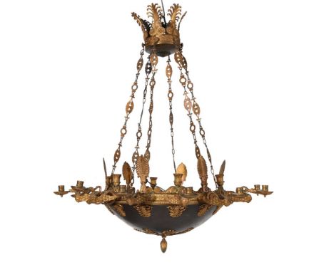 A GILT METAL TWELVE LIGHT CHANDELIER FRENCH 19TH CENTURY, IN THE EMPIRE MANNER With winged beast candle branches, original pi