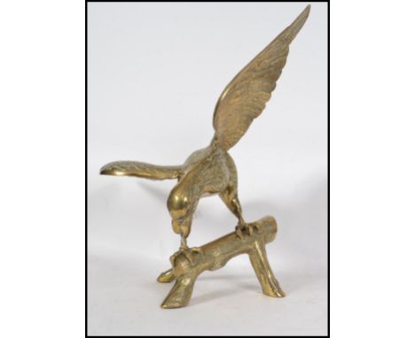 A vintage 20th century large brass eagle figurine raised on branch style plinth base. Measures 60cm high.