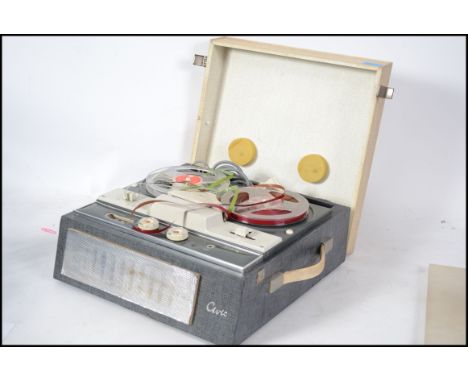 A vintage mid 20th century reel to reel player by Civic with tape to the inside.