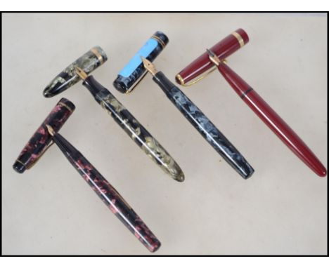 A collection of three vintage 20th century fountain / ink pens to include a Swan self filler Mabie, |Todd and Co with a 14 k 