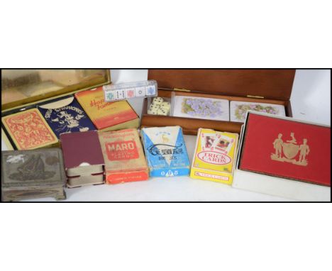 A collection of playing cards to include Happy Families, Shuffle Symphonies,Maro, Trick Cards along with cases etc