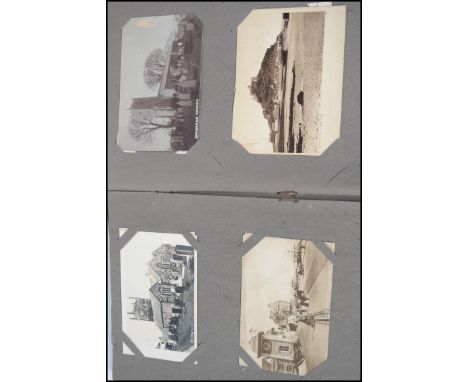 An early 20th century Edwardian postcard album featuring a range of vintage postcards - topographical, real photo, some of mi