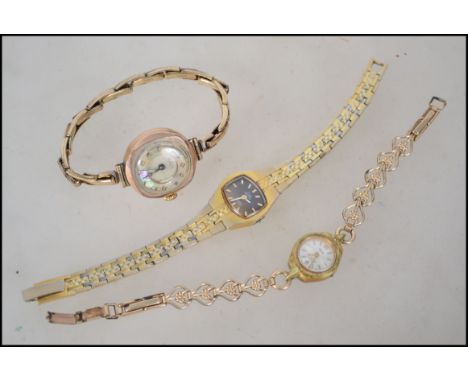 A group of three ladies wrist watches. &nbsp;One Claridge gold plated cushion Swiss made piece with a mother of pearl dial fa