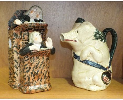 An Orchies-style vintage French majolica pitcher in the form of a pig carrying a ham on a sash around its body, 20.5cm high a