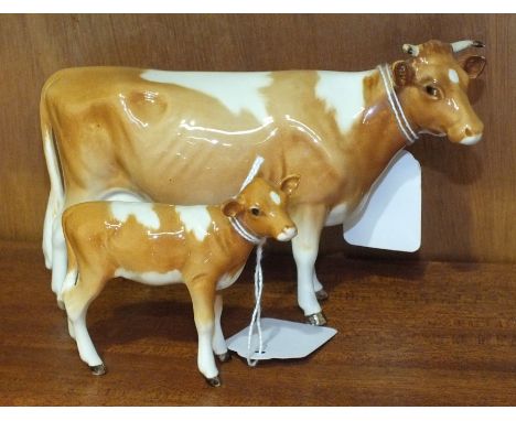 A Beswick Guernsey cow, (first version), 11cm high and a Guernsey calf, 7cm high, (2).