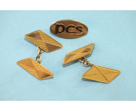 A pair of engine-turned 9ct gold cufflinks of parallelogram form, 3.9g and a 9ct gold tie tack.