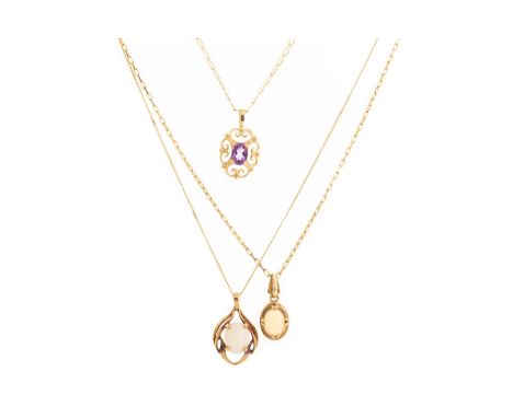 THREE PENDANTS ON CHAINS, IN NINE CARAT GOLD  one pendant set with an oval amethyst, the other two with an oval opal, along w