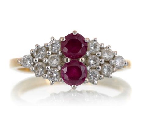 RUBY AND DIAMOND RING, IN EIGHTEEN CARAT GOLD  set with two rubies flanked with twelve round diamonds in a lozenge shapeQty: 