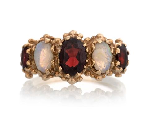 VICTORIAN STYLE GARNET AND OPAL RING, set with alternating oval garnets and opals, in nine carat gold, Birmingham 1975Qty: 3.