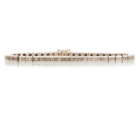 DIAMOND TENNIS BRACELET, set with a row of baguette cut stones, in unmarked white goldQty: 19.97gWell worn condition. Require