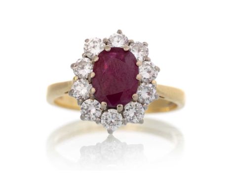 RUBY AND DIAMOND CLUSTER RING, set with an oval ruby within a halo of diamonds totalling approximately 0.60 carats, in eighte