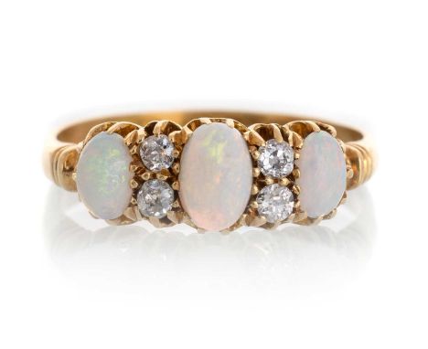 OPAL AND DIAMOND RING, IN EIGHTEEN CARAT GOLD  set with three oval cabochon opals spaced by four round old brilliant cut diam