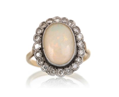 LATE VICTORIAN OPAL AND DIAMOND RING, IN EIGHTEEN CARAT GOLD  the oval opal in a surround of round diamondsQty: 4.3gShank mis