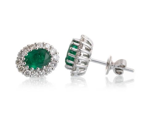 PAIR OF EMERALD AND DIAMOND CLUSTER EARRINGS, set with oval emeralds totalling approximately 1.75 carats, within diamond halo