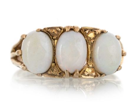 OPAL THREE STONE RING, set with three oval cabochon opals, in nine carat gold, size L 1/2Qty: 3.1g