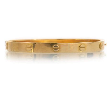 MIDDLE EASTERN GOLD BANGLE, IN THE STYLE OF A CARTIER 'LOVE BANGLE'  the oval bangle with screwhead designs around, unmarked 
