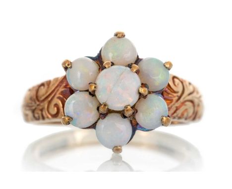 OPAL CLUSTER RING, IN NINE CARAT GOLD  set with round opals, with scrollwork decoration to the shoulders, size L 1/2Qty: 3.2g