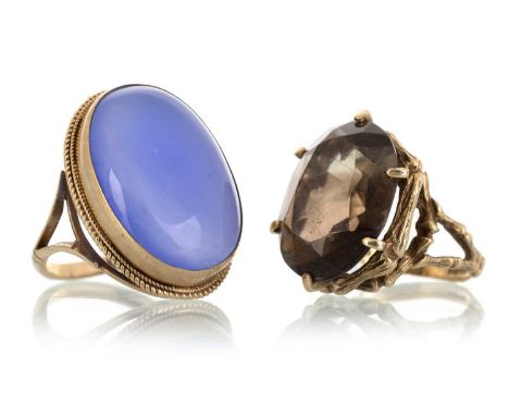 TWO GEM SET DRESS RINGS, comprising a smoky quartz and a chalcedony, each in nine carat gold, size L &amp; RQty: 15.8g