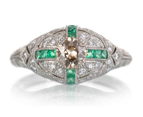 EMERALD AND DIAMOND RING, set with central brown diamond to an emerald and diamond set mount, in platinum, size MQty: 5g