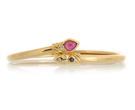 RUBY, SAPPHIRE AND DIAMOND SNAKE BANGLE, set with a round sapphire, round diamonds and pear cut ruby, in eighteen carat gold 